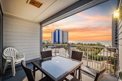 Balcony featuring a water view and outdoor dining area