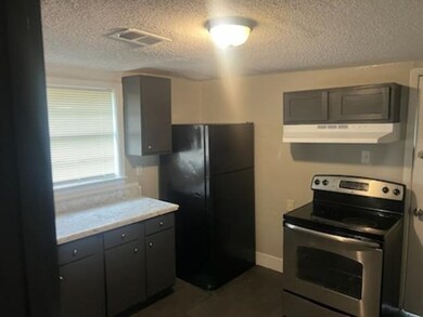 Kitchen with gray cabinetry, electric range, black