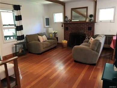 Living room with warm hardwood floors, fireplace, 