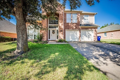 View of front of house with a garage, a front yard