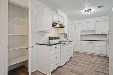 Kitchen with white cabinets, white appliances, dec