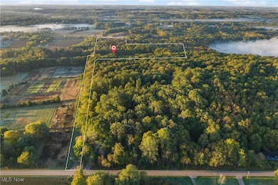Aerial overview of property's location featuring a large body of water and property parcel outlined