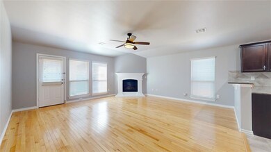 Large living room featuring ceiling fan, light har