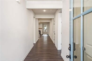 Hallway with dark hardwood / wood-style floors and