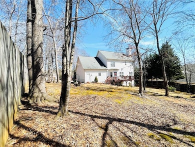 View of property exterior with a chimney, a deck, 