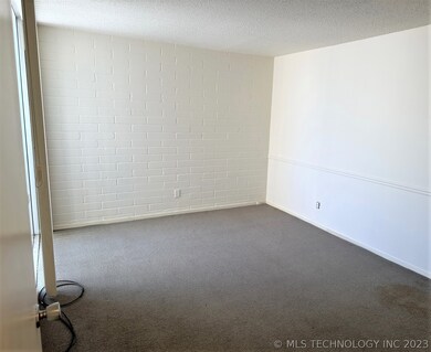 Bedroom with fun brick wall accent, and floor to c