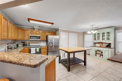Kitchen featuring crown molding, stainless steel a