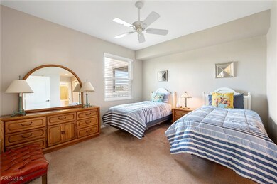 Bedroom with light carpet and ceiling fan