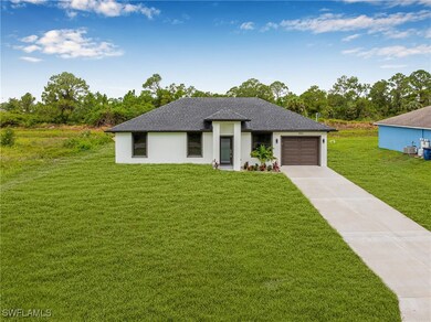 Prairie-style house with driveway, a front lawn, a