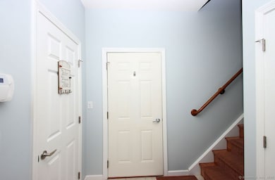 Step In From the garage and there is a roomy foyer and stairs to your unit.