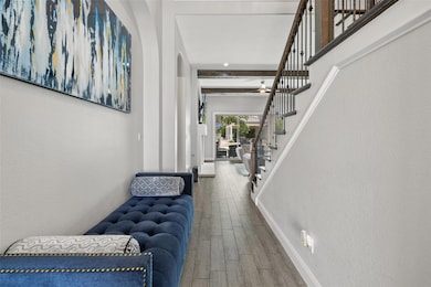 Foyer entrance featuring wood finished floors, st