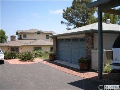 View main house, two car garage and  three carport
