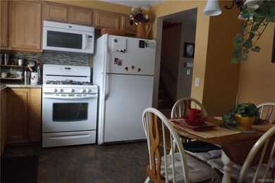 Eat in kitchen with new floor & glass back splash.
