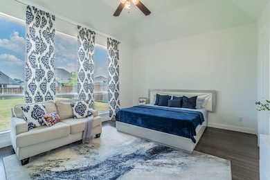 Bedroom with wood finished floors and a ceiling fan