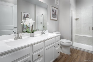 Full bathroom featuring a stall shower, a sink, to