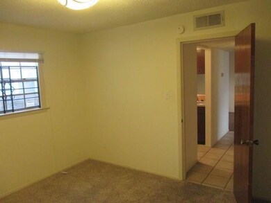 Unfurnished room with light colored carpet and li