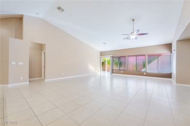 Unfurnished room with light tile patterned flooring, high vaulted ceiling, and ceiling fan
