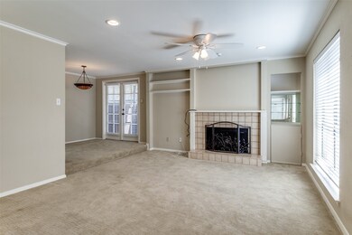 Unfurnished living room featuring ornamental molding, carpet, a ceiling fan, a fireplace, and recessed lighting