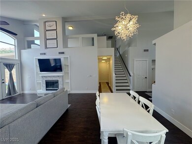 Dining area with visible vents, stairs, a towering
