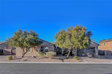 Front of home with desert landscaping, pavered dri