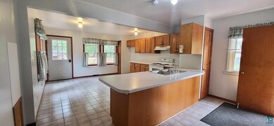 Kitchen featuring sink, light tile patterned floor