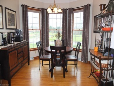 Gorgeous dinette has wood flooring, vaulted ceilin