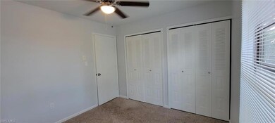 Unfurnished bedroom featuring carpet floors, two closets, baseboards, and a ceiling fan