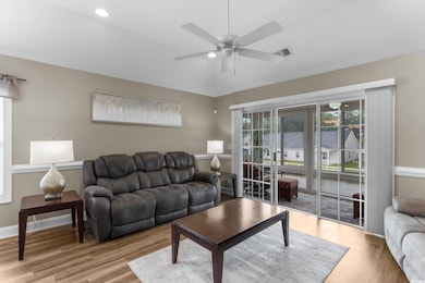 Living room with light hardwood / wood-style floor