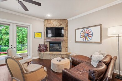 Living room with ornamental molding, a ceiling fan