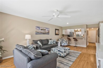 Living area featuring baseboards, light wood-type