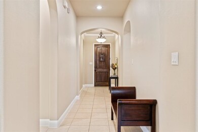 Main hallway looking towards custom wood front door complete with speakeasy window