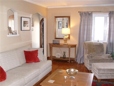 Living room with archway to front door.