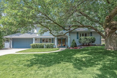 A beautiful summer photo of the front of the home.