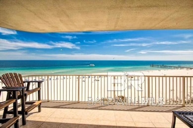 Balcony with view of water and beach