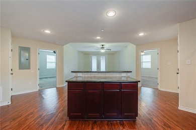Kitchen featuring electric panel, a kitchen island