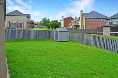 View of yard featuring a trampoline and a residential view