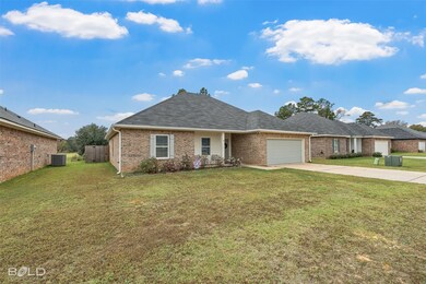 View of front facade featuring concrete driveway, brick siding, an attached garage, and roof with shingles
