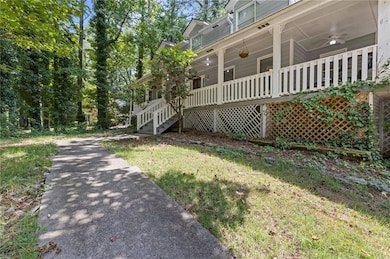 View of home's exterior with a porch, ceiling fan, and stairs