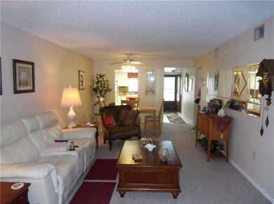 LIVING AREA TO KITCHEN AND FOYER ENTRY