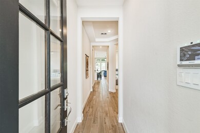 Entry features wood look tile floors and trayed ce