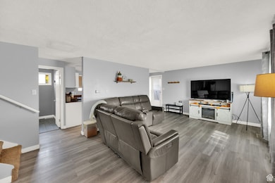 Living area featuring a textured ceiling and wood finished floors
