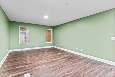 Spare room featuring wood finished floors and a smoke detector