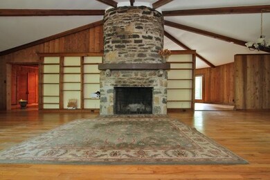 The stone wood burning fireplace is the center piece of the home.