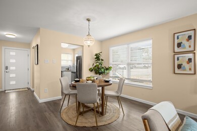 Dining space with baseboards, dark wood-style flo