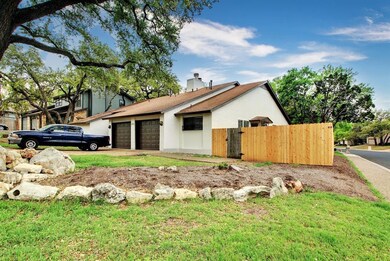 View of side of property with driveway, a chimney