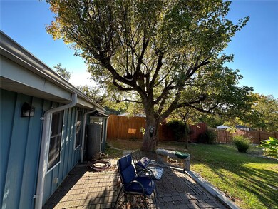 Back of home with brick patio and a beautiful shad