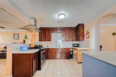This kitchen offers quarts countertops, subway til