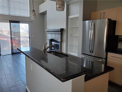 Kitchen featuring freestanding refrigerator, a si