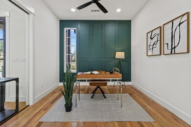 Office space featuring ceiling fan and light wood-