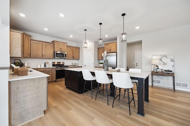 Spacious kitchen with large center island, stainless steel appliances, and ample cabinet space - perfect for cooking and entertainment.